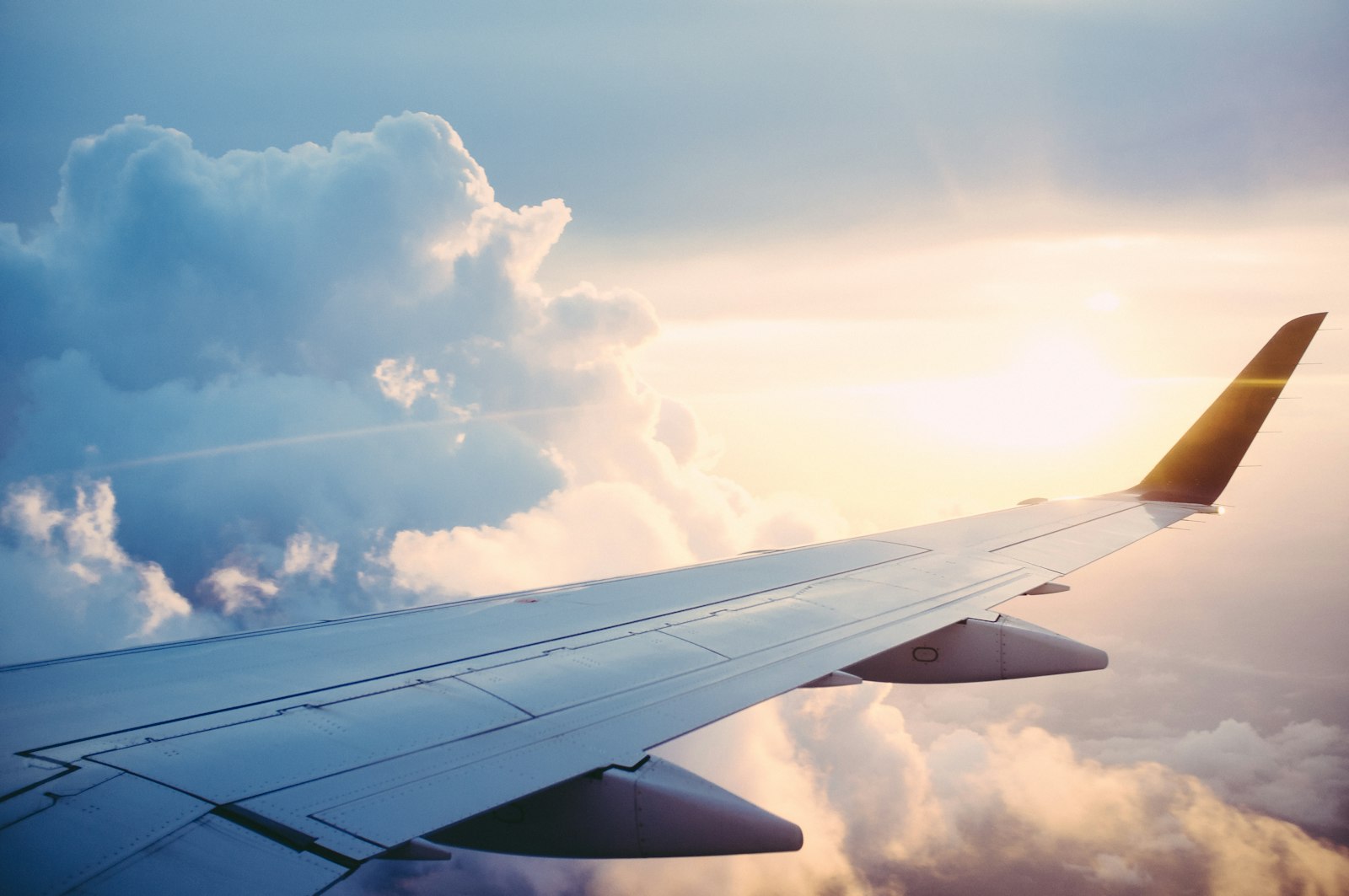 Airplane wing above clouds